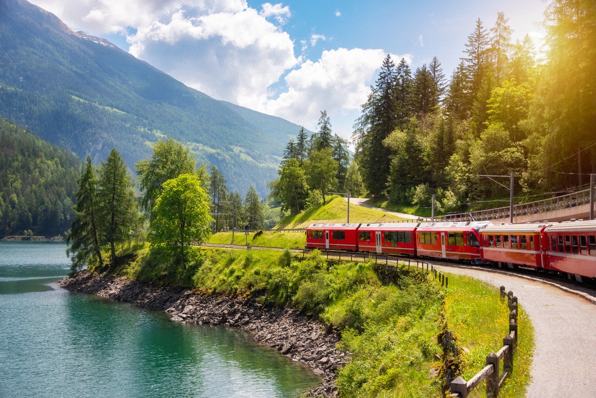 Red Bernina Railway train beside Lake Poschiavo